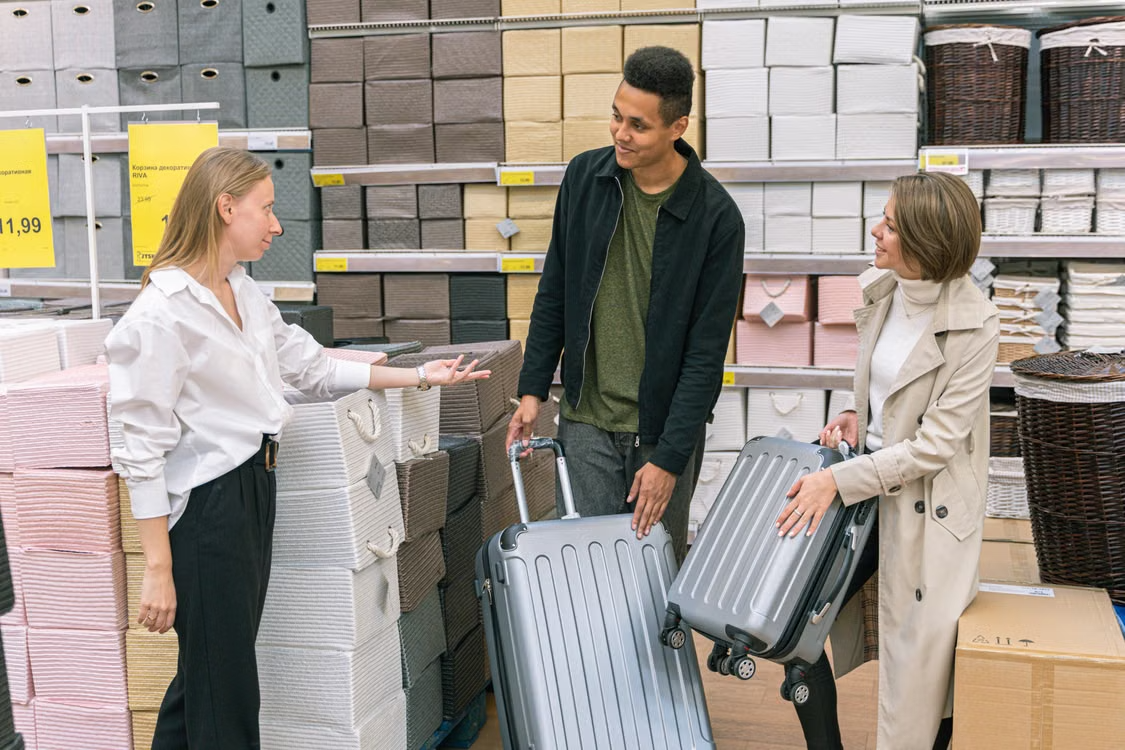 Shoppers comparing luggage in a home goods store