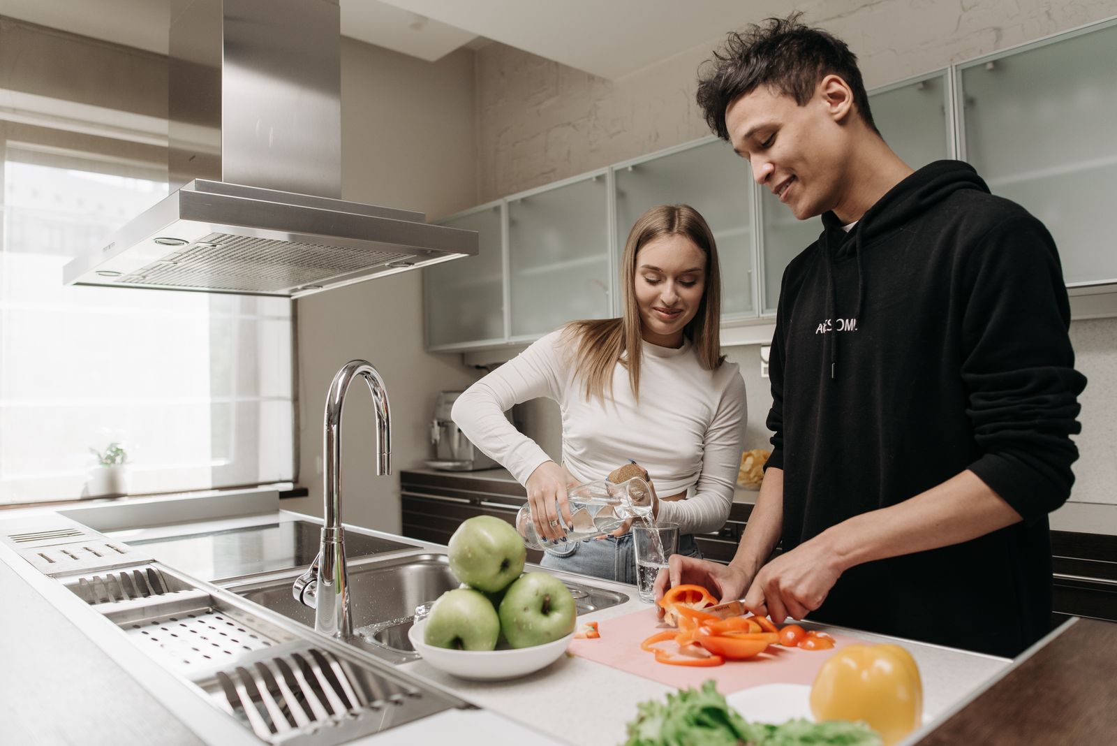 Couple preparing food together in an everyday kitchen