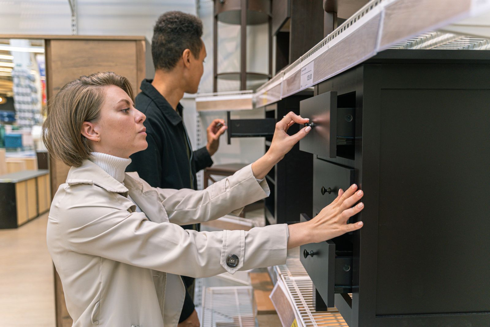 Shoppers examining furniture and construction details